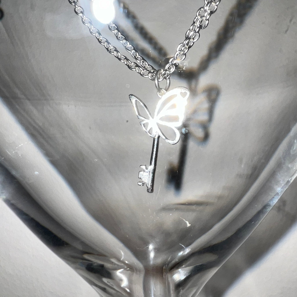 Silver butterfly key-shaped pendant